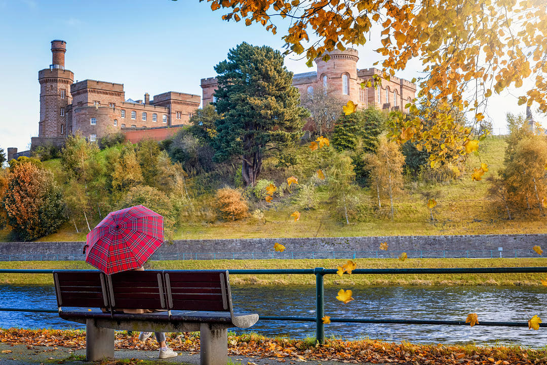 Tourist enjoying the view of Inverness Castle in Scotland
