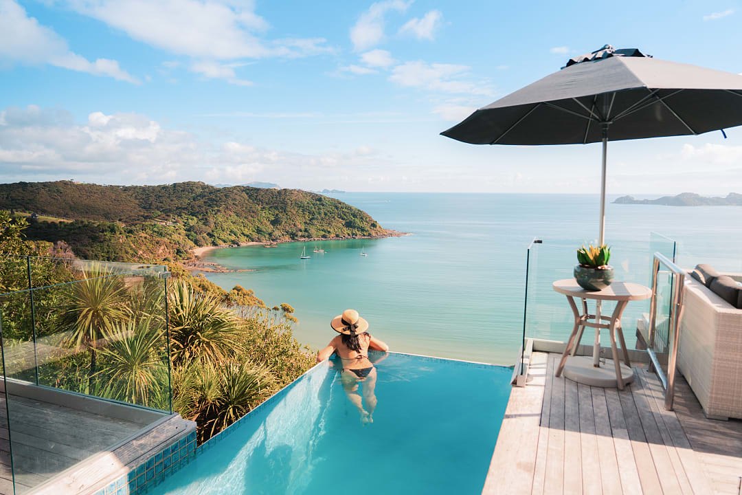 A woman enjoys a dip at the Bay of Islands, New Zealand