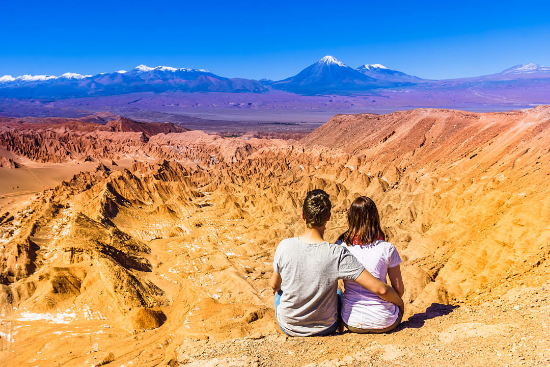 Couple taking in a view of the Atacama Desert in Chile
