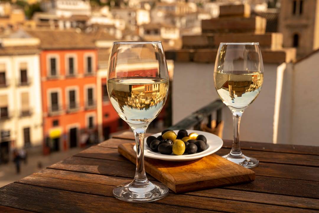 A quiet break in Andalusia with wine, olives, and a city view.