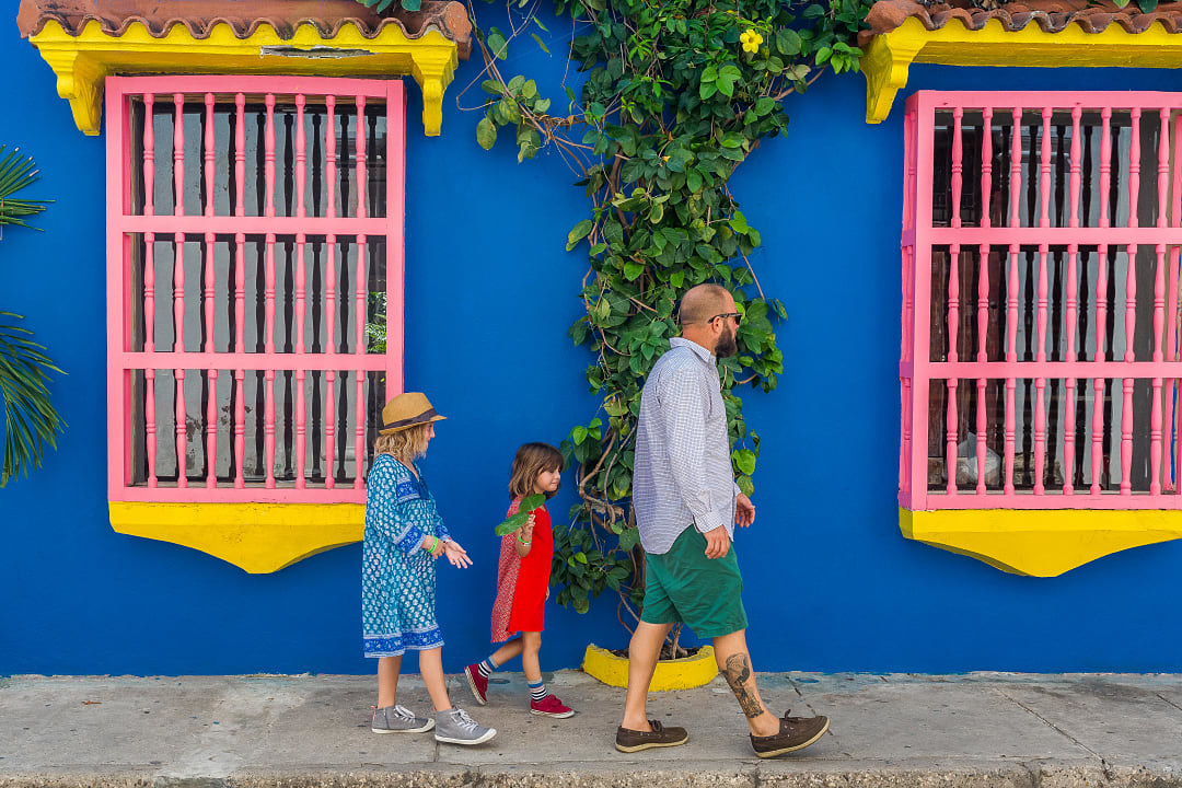 Father and daughters walking in colorful Cartagena, Colombia