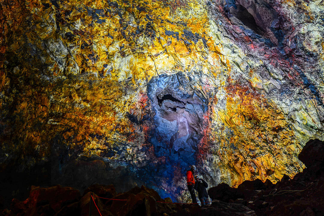 Tourists and guides inside the colorful caldera of Thrihnukagigur volcano