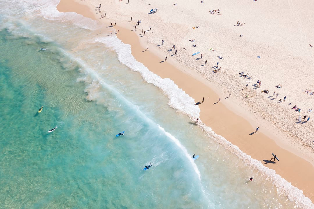 Aerial view of people swimming in Bondi Beach, Australia.