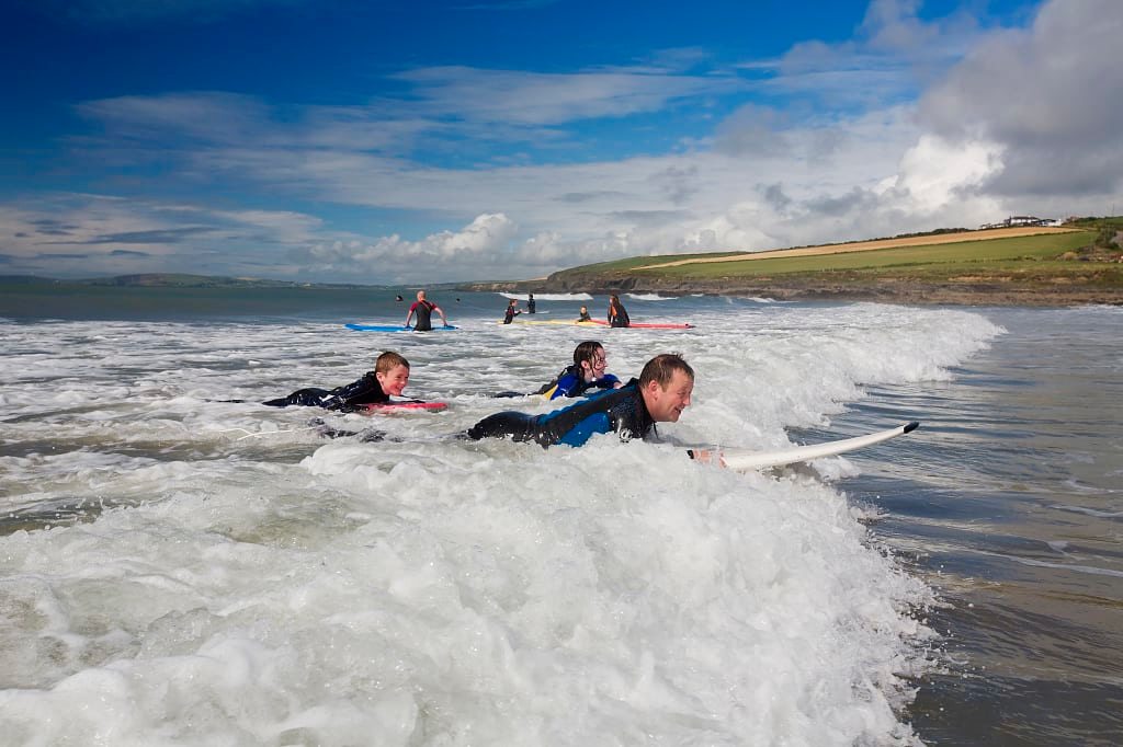 Family surfing at Garretstown Beach in Ireland. Photo courtesy of Brian Morrison / Tourism Ireland