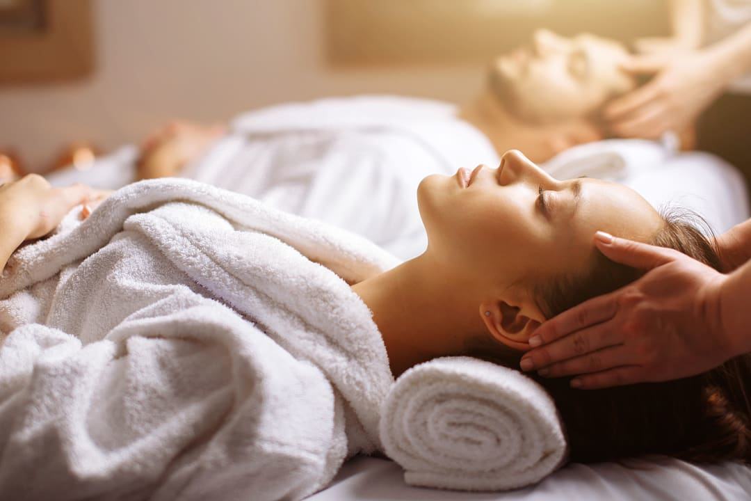 Couple receiving a head massage