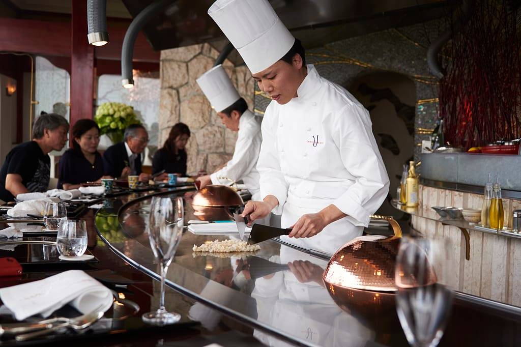Chef preparing food at restaurant in Tokyo, Japan