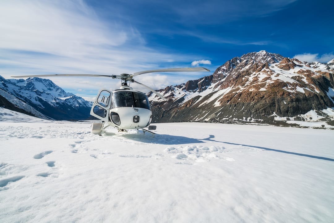 A private helicopter taking off on Mount Cook, New Zealand.