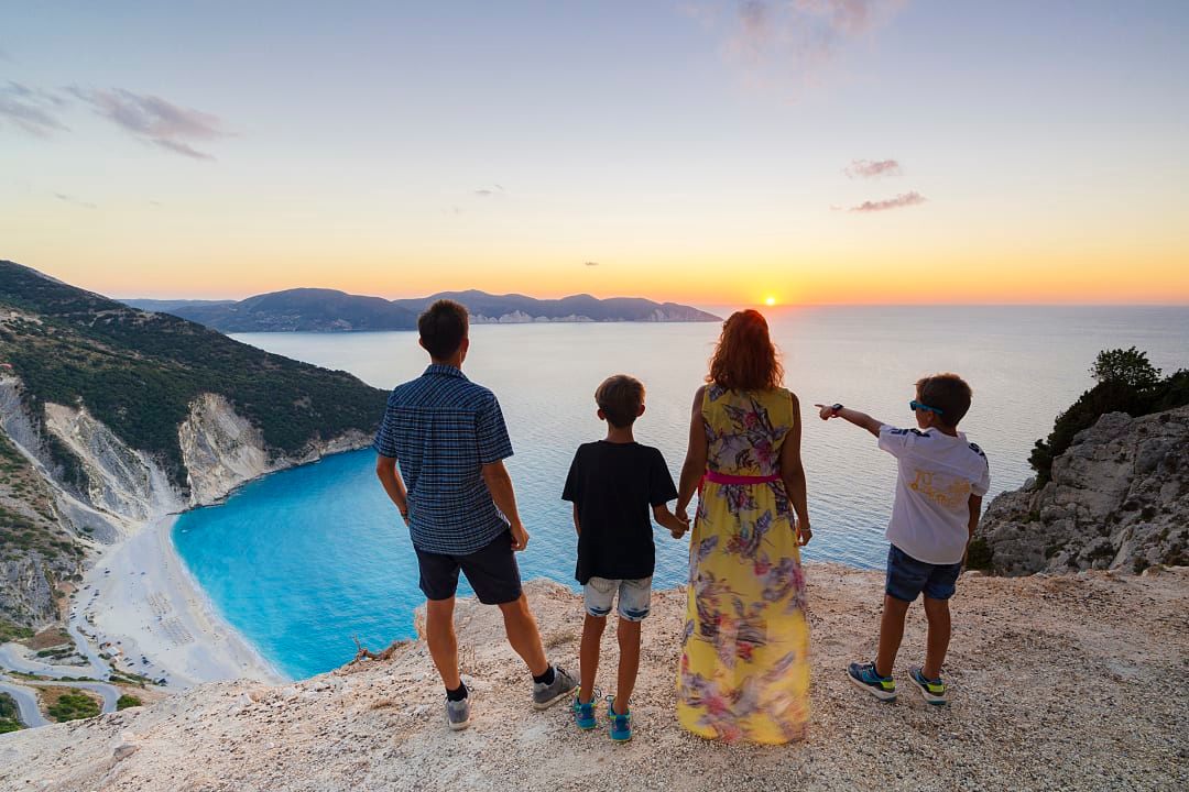 A family admires the view of Myrtos Beach on Kefalonia Island, Greece