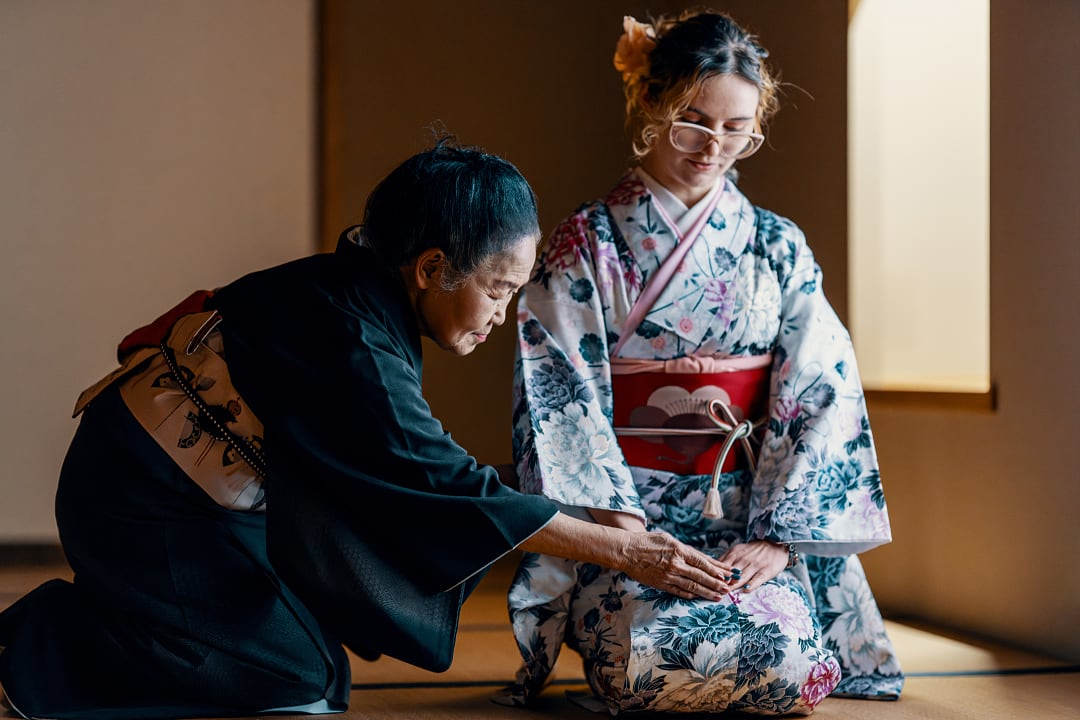 Traditional Japanese tea ceremony instruction in a tatami room.