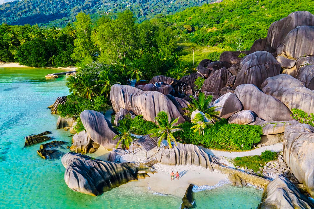Couple walking in La Digue Island, Seychelles.