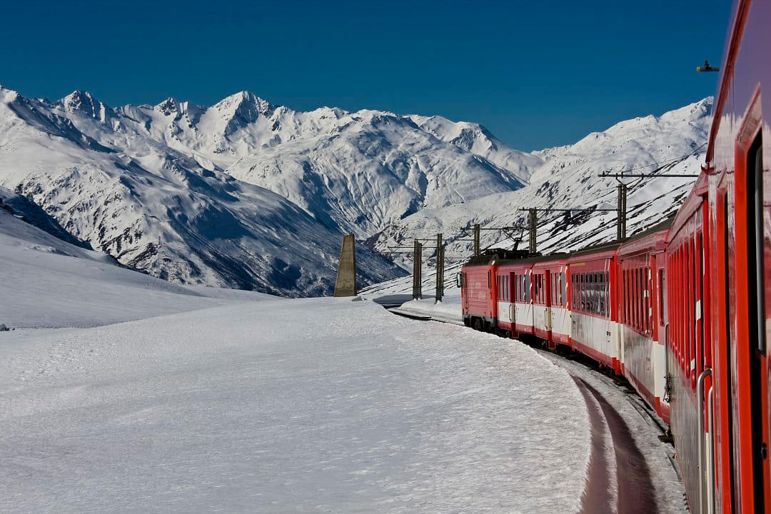The Glacier Express Train in the Oberalppass alps mountains.
