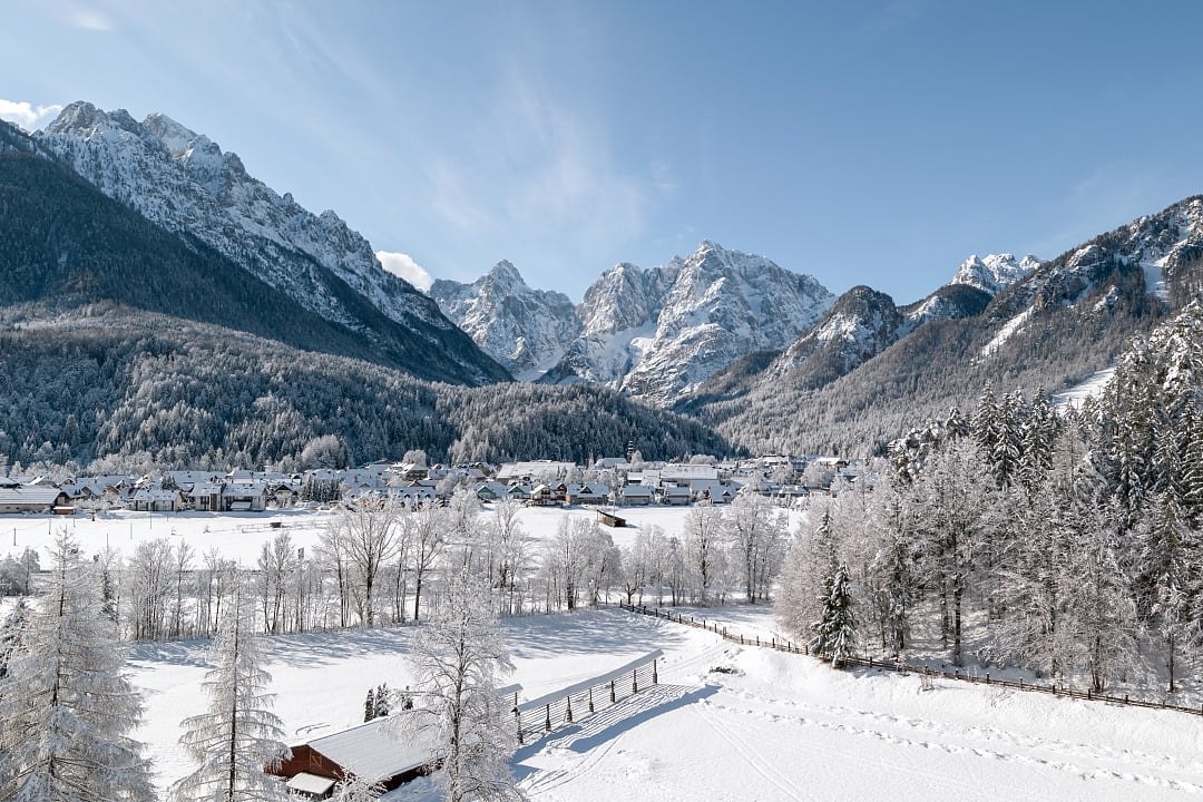 Snowy alpine valley village surrounded by mountains