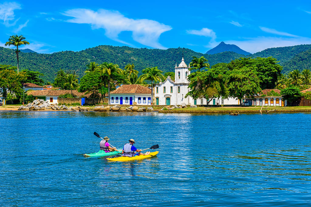 Couple kayaking in Paraty in Rio de Janeiro, Brazil.