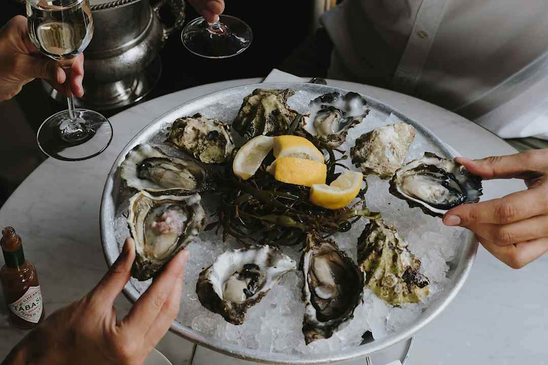 Couple enjoying oysters and champagne.