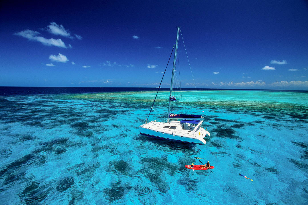 A catamaran in the turquoise waters of Belize.