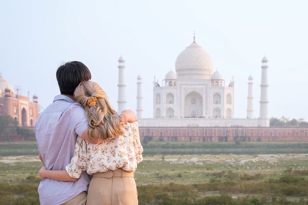 Couple admiring the Taj Mahal in Agra, India.