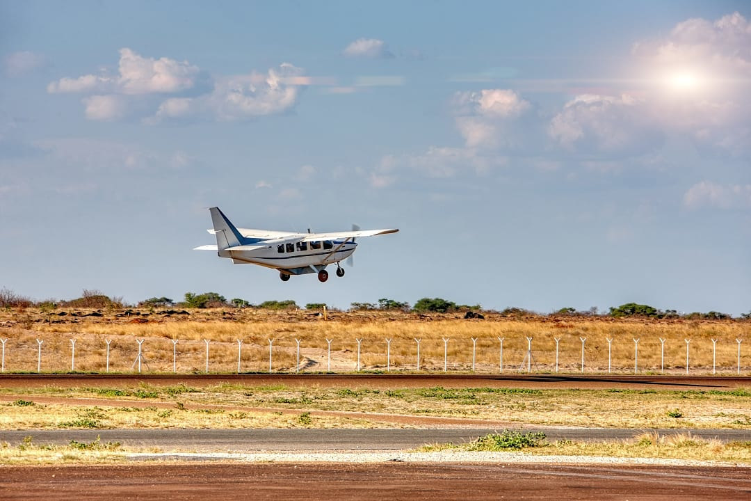 A private plane descending onto an airstrip, a classic entry point for a safari adventure.