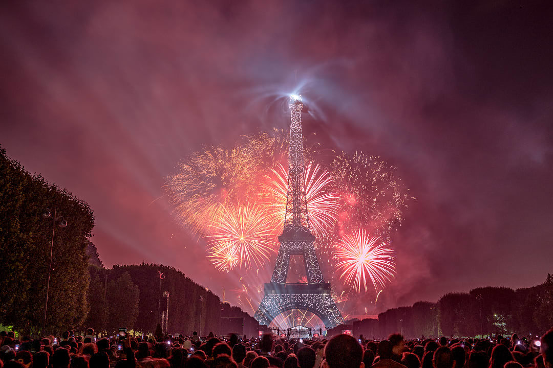 Fireworks explode over the Eiffel Tower on Bastille Day in Paris France 