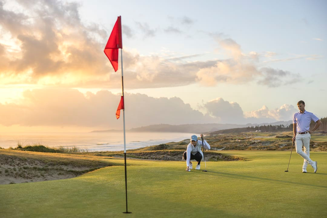 Couple golfing at Te Arai Links in Auckland, New Zealand