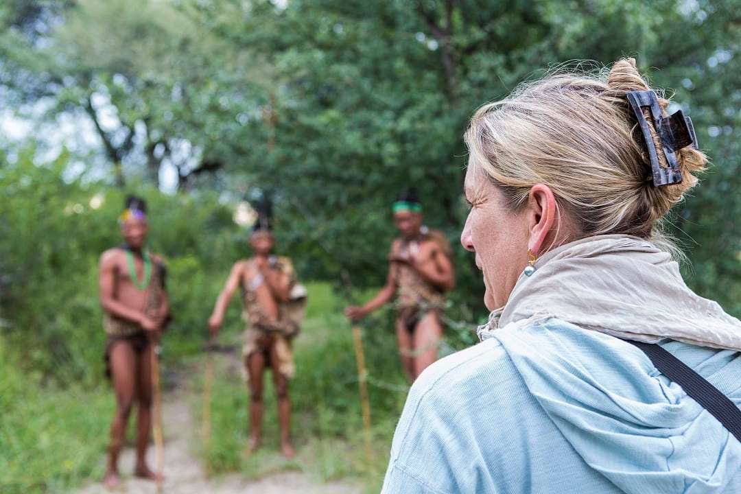 Woman meeting members of the San People Tribe in Boswana