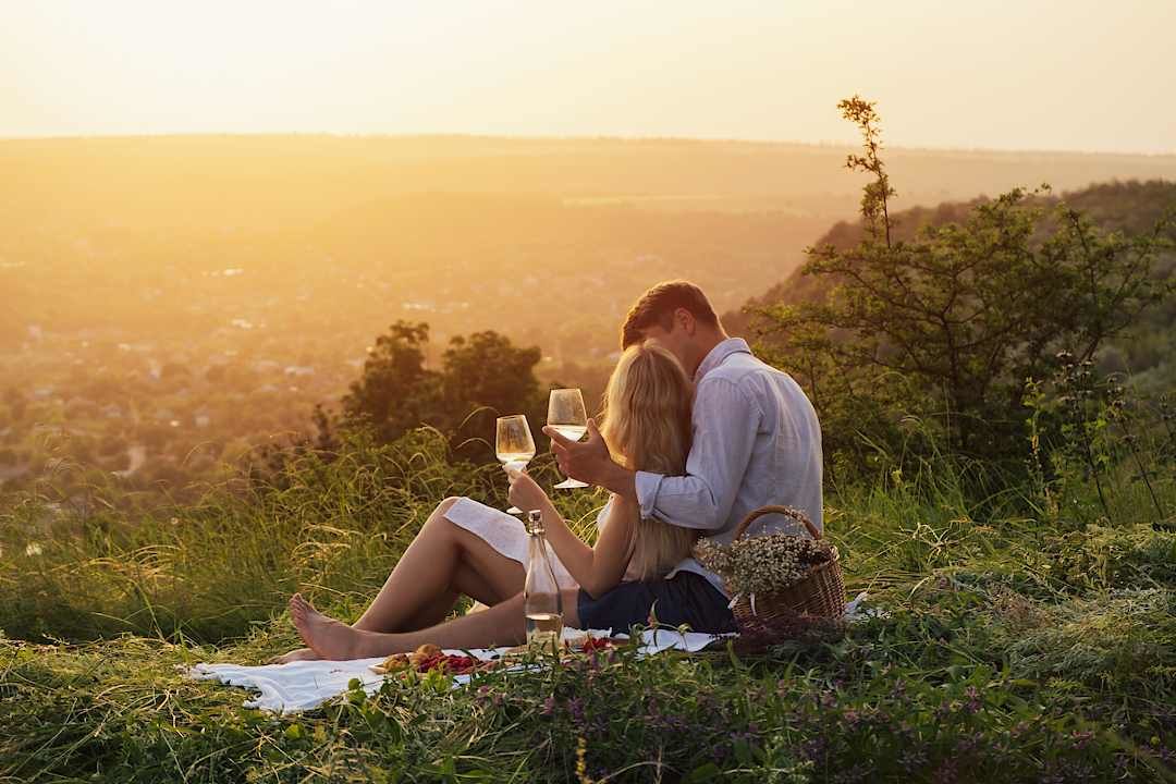 Couple enjoying a picnic at sunset, Italy.