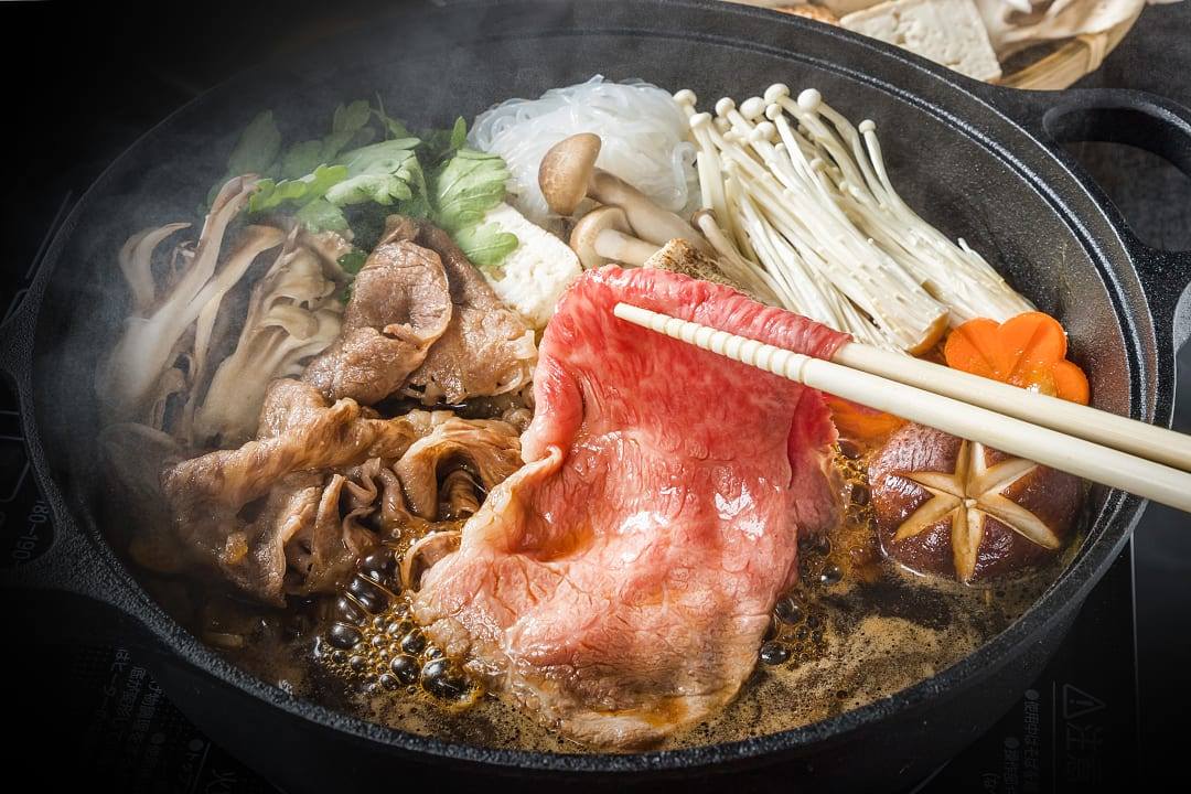 Seasonal matsutake mushrooms in steaming sukiyaki