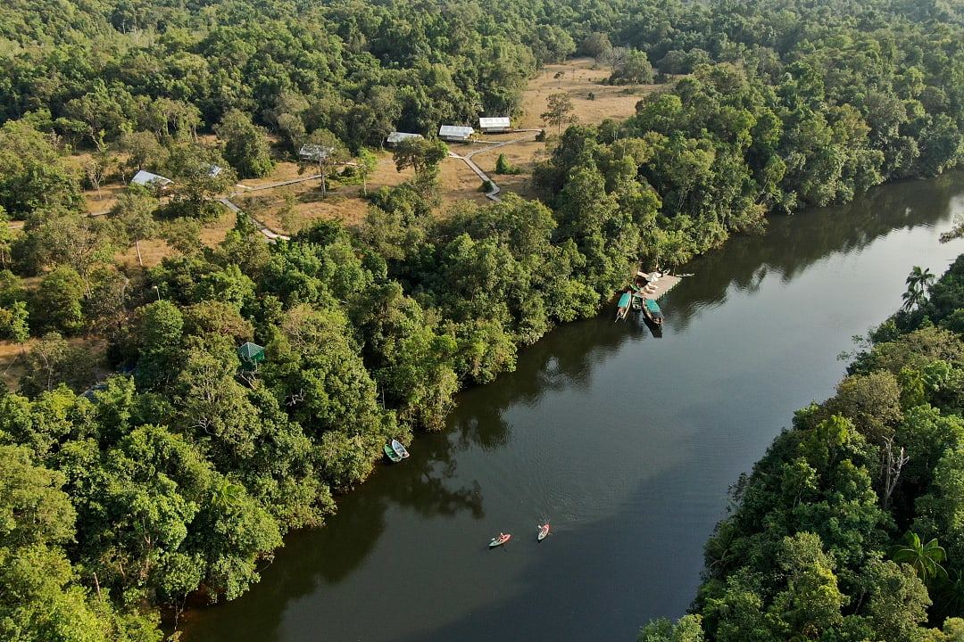 Kayakers on Prek Tachan river next to Cardamom Tented Camp in Koh Kong Province, Cambodia