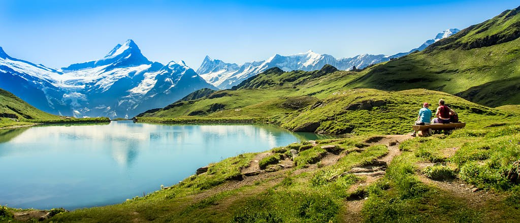 Couple resting from hiking around Lake Zermatt with views of the Matterhorn