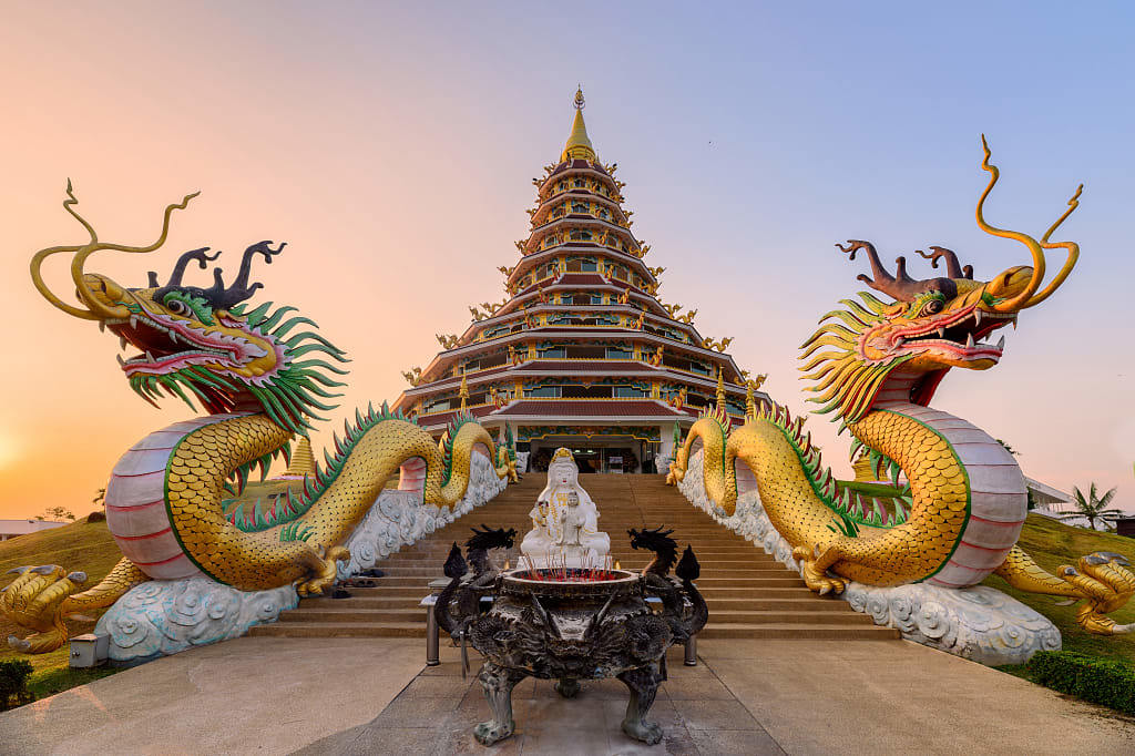 Colorful dragons statue with Pagoda at sunset
