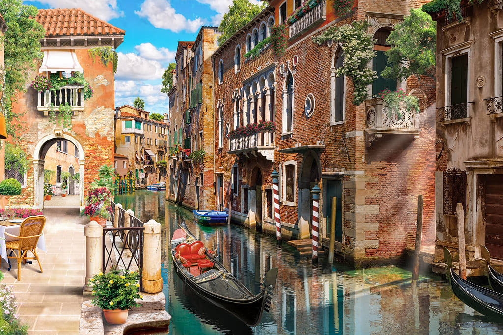 Gondola on quiet canal next to restaurant in Venice, Italy