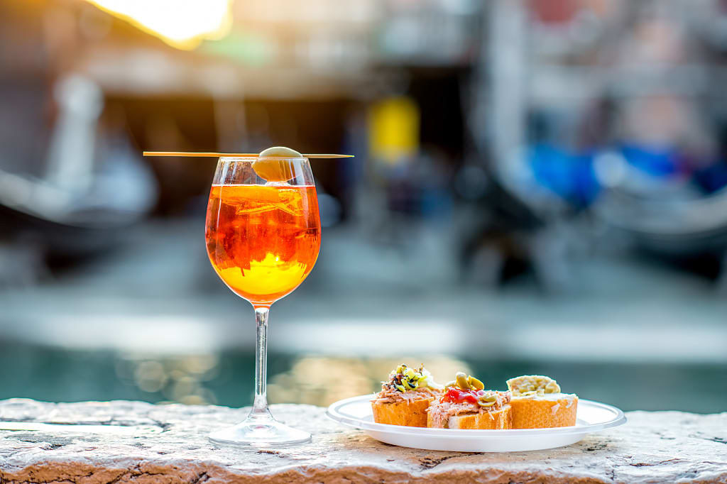 Traditional aperitif at cicchetti bar on the canal in Venice