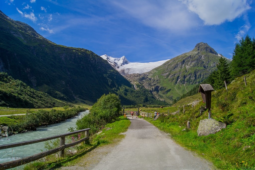 Hiking along river in Tauren valley with view of Großvenediger