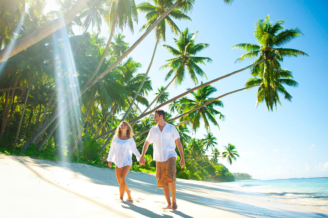 Couple walking on an idyllic tropical beach