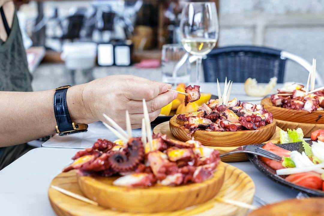 Octopus and wine served at a restaurant in Cambarro, Galicia, Spain