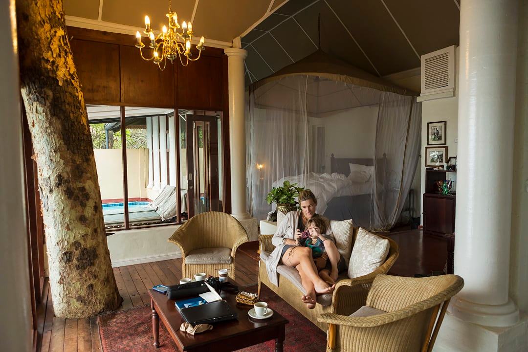A mother and child relax in a luxury safari lodge retreat.