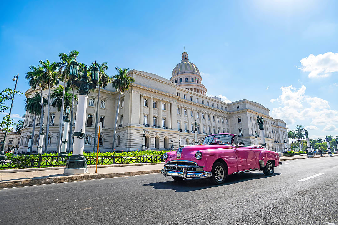 A vintage American convertible car in front of the capitol in Havana, Cuba