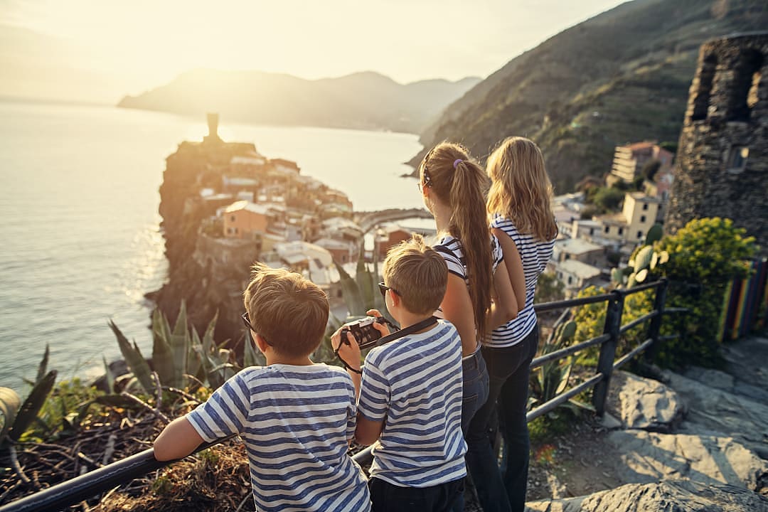 Family on hiking trail overlooking Vernazza in the Cinque Terre, italy