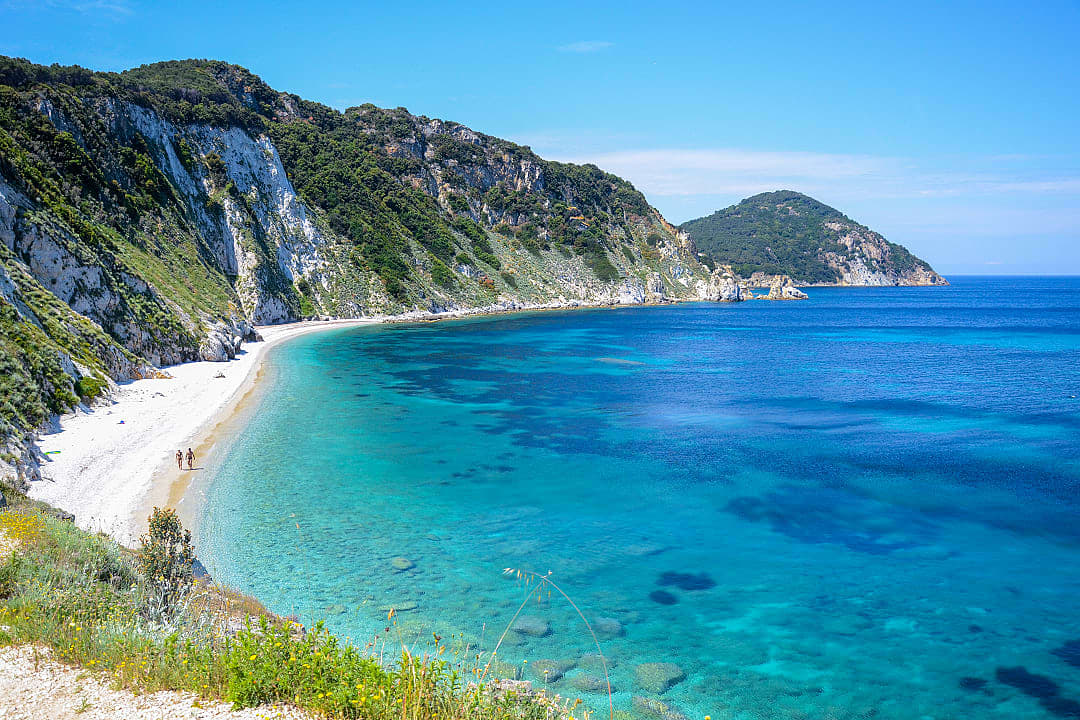 Couple strolling Sansone Beach on Elba Island, Italy