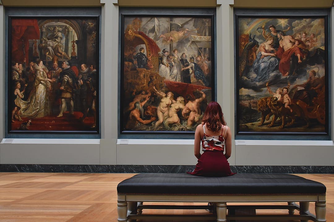 A visitor admires timeless masterpieces inside the Louvre Museum, Paris.