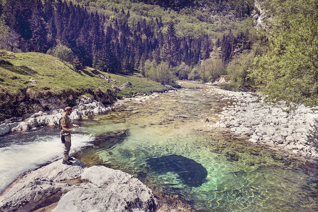 Fly fishing in the Soča River in Slovenia.