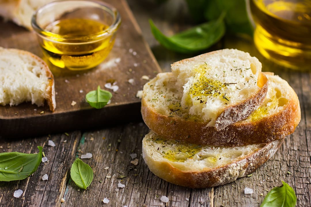 Golden olive oil drizzled over rustic bread