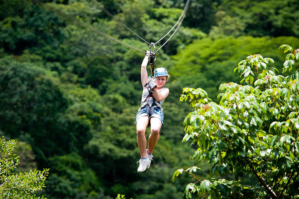 Young traveler ziplining in Costa Rica