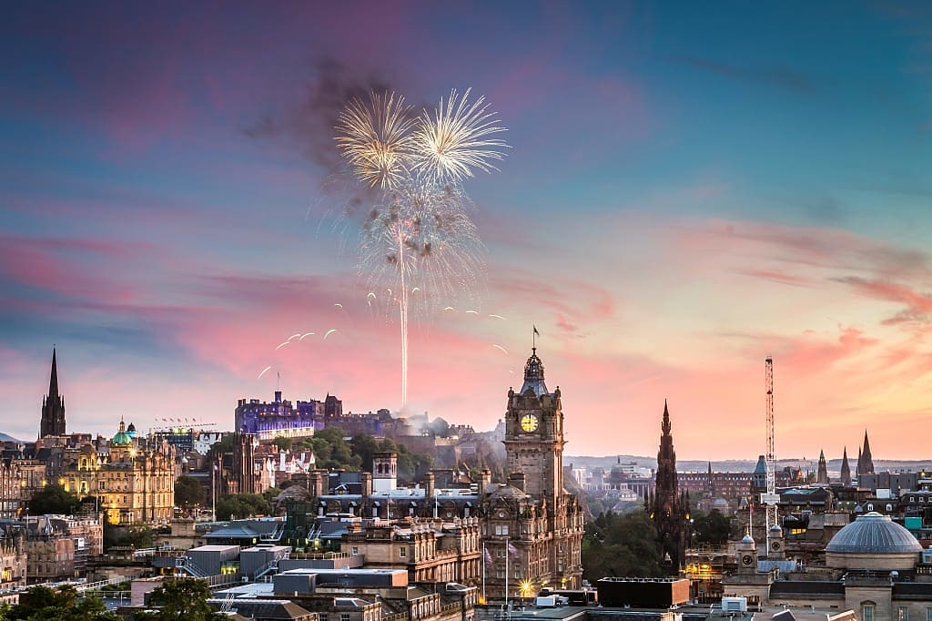 Edinburgh Castle at sunset with fireworks in Scotland