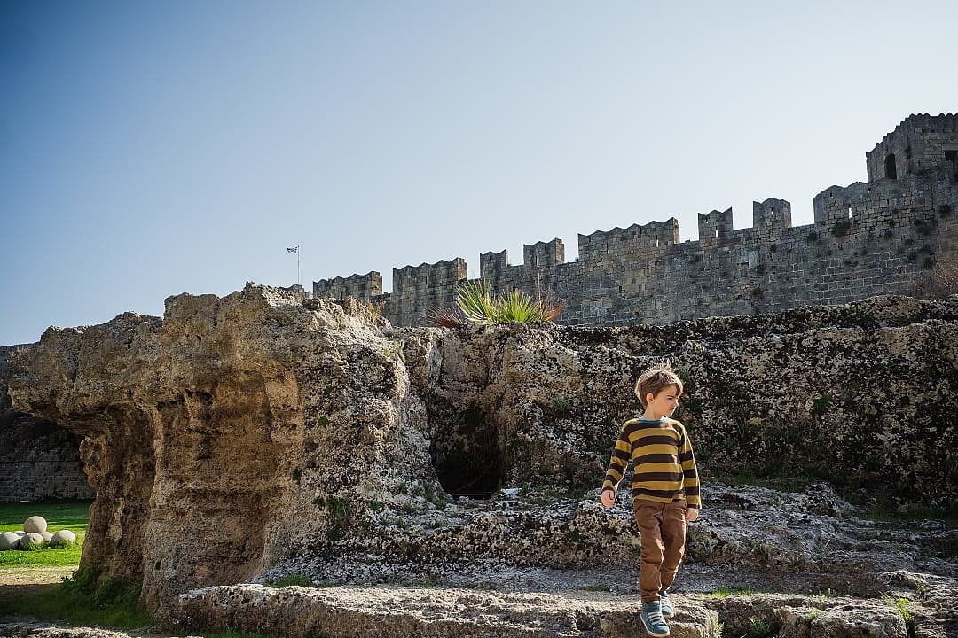 Boy exploring the medieval fortress in Rhodes, Greece
