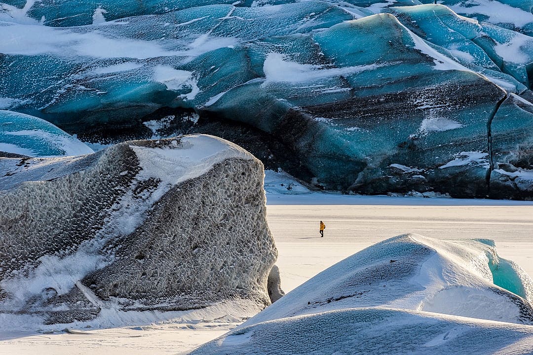 Hiker exploring Svínafellsjökull Glacier in Skaftafell Nataionall Park, Iceland