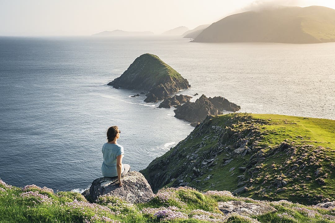 A woman enjoying the landscapes of the Dingle Way in County Kerry, Ireland.