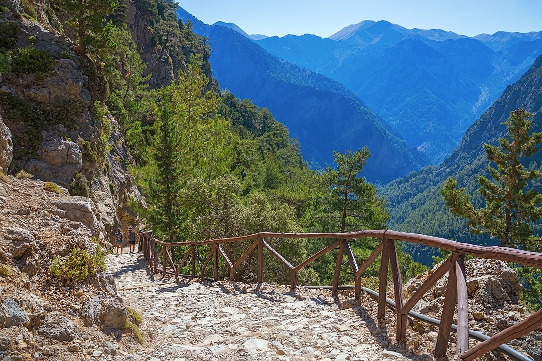 Two travelers on hiking path Samaria Gorge on the island of Crete, Greece