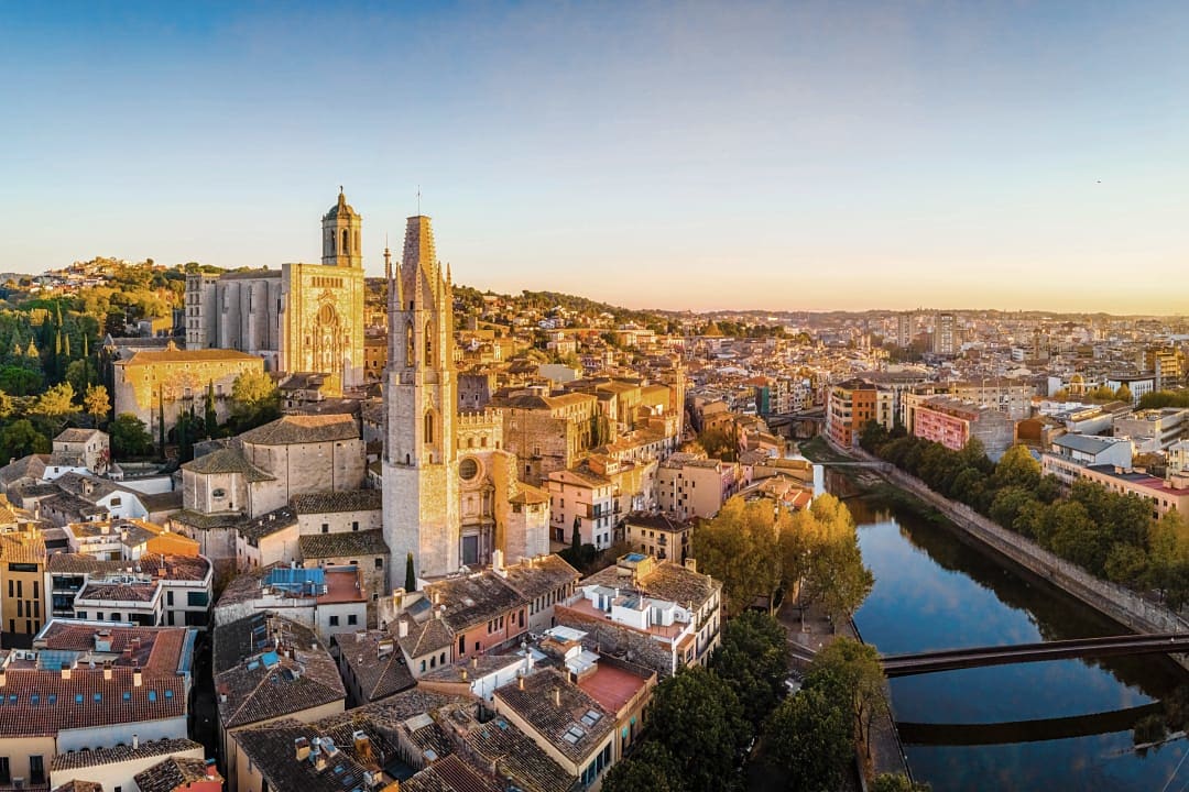 Aerial view of Girona’s Old Town with the cathedral and Onyar River at sunset, Catalonia, Spain
