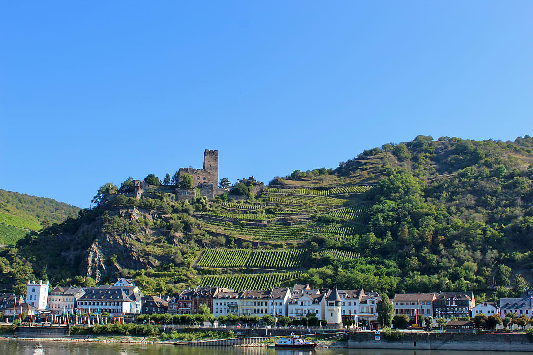 Bacharach, Germany with vineyards, half-timbered houses, and Stahleck Castle above the Rhine River.