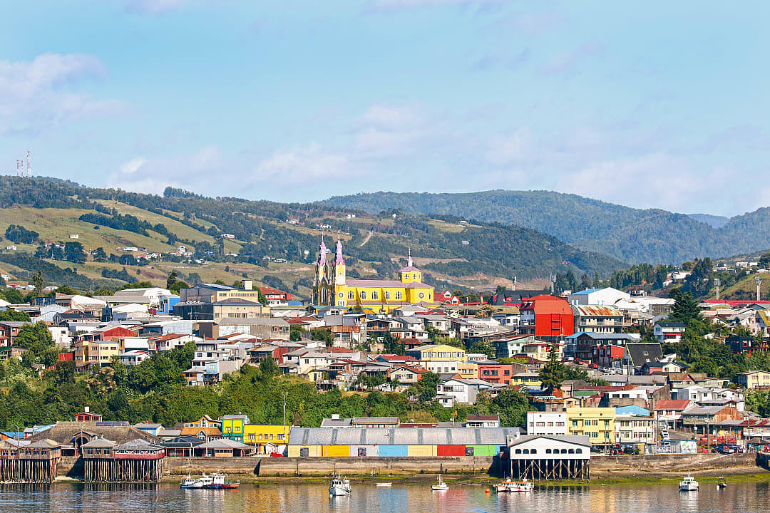 Colorful town of Castro on Chiloé Island, Chile, with the iconic yellow and purple San Francisco Church.